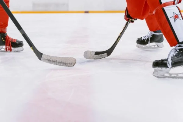 hockey players battling for puck